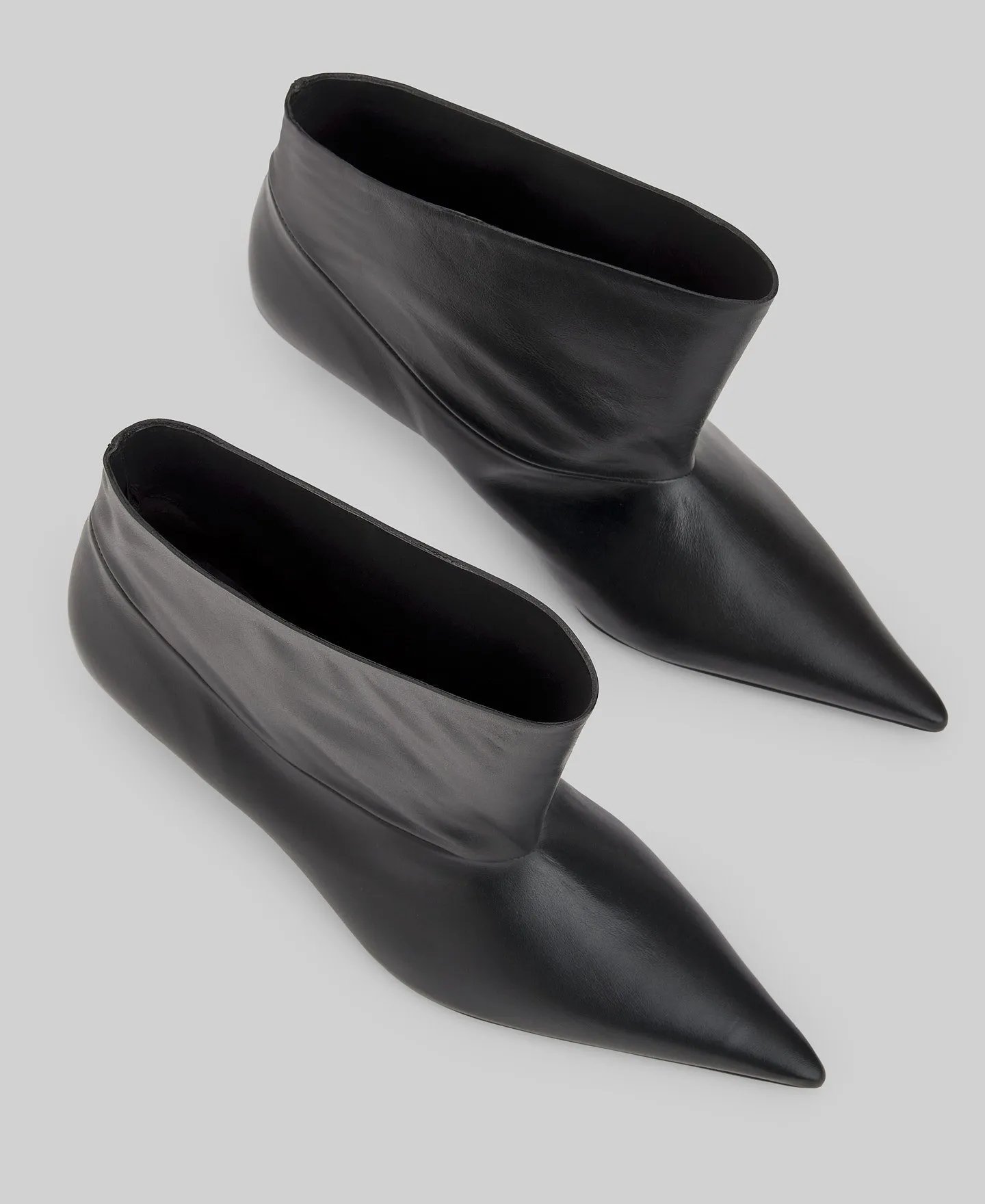 Asymmetric leather ankle boots woman